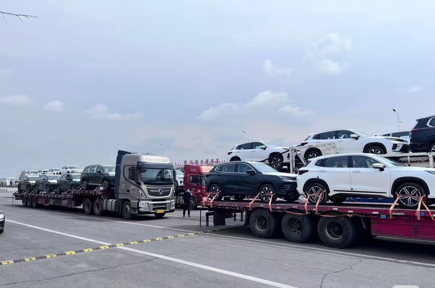Car carrier trucks delivering vehicles to the port
