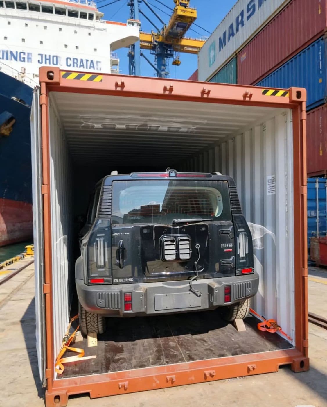 Jetour SUV secured with straps inside a shipping container