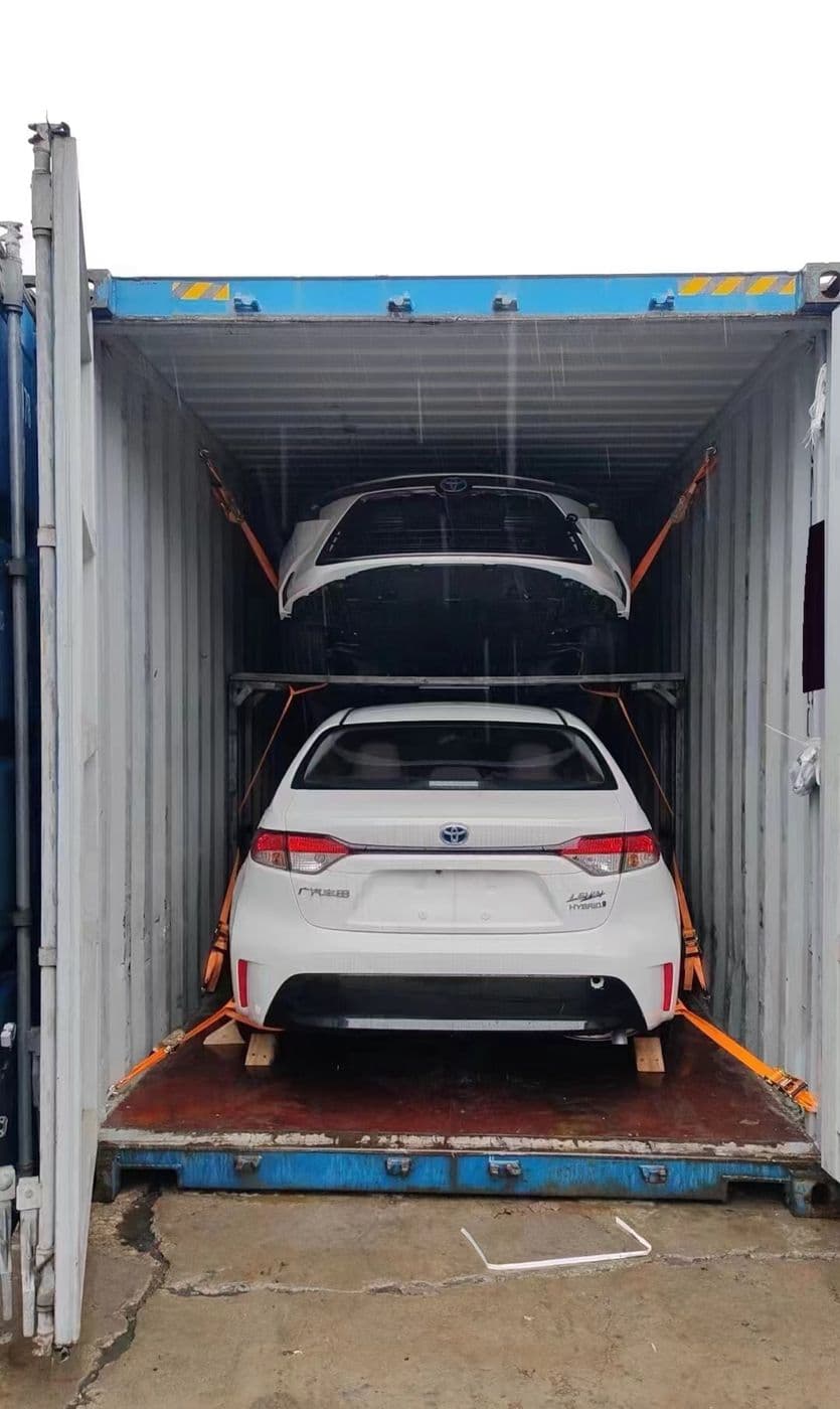 White SUV secured inside a 40HQ container for island shipping